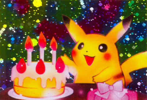 A close-up of the art on the classic Birthday Pikachu card. Pikachu happily reaches toward a birthday cake on a holographic background.